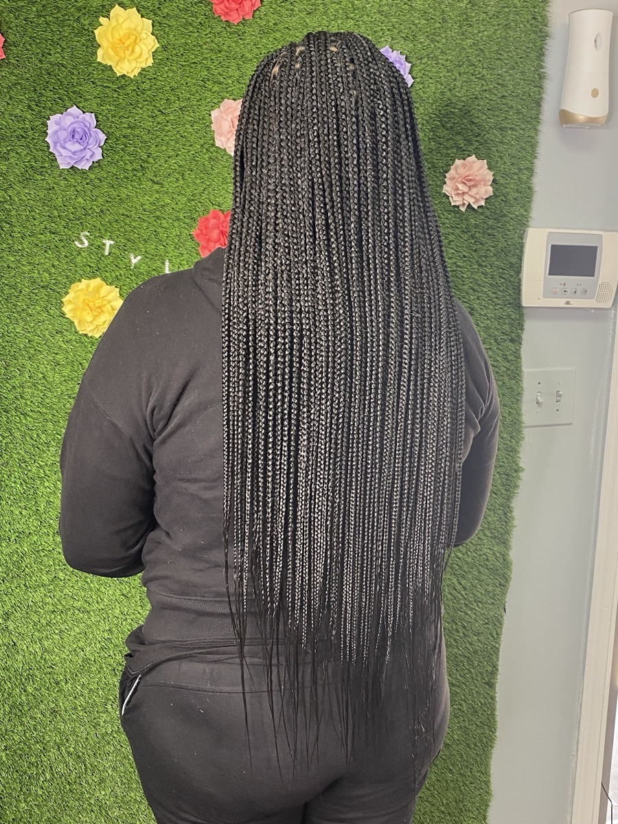Long, neat knotless box braids styled at 3JJJ Hair Braiding in Stockbridge, GA